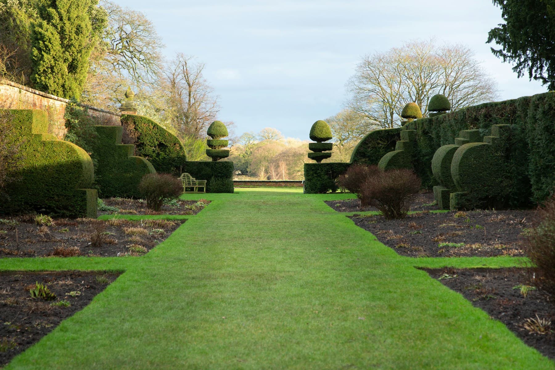 A maintained lawn framed by hedges